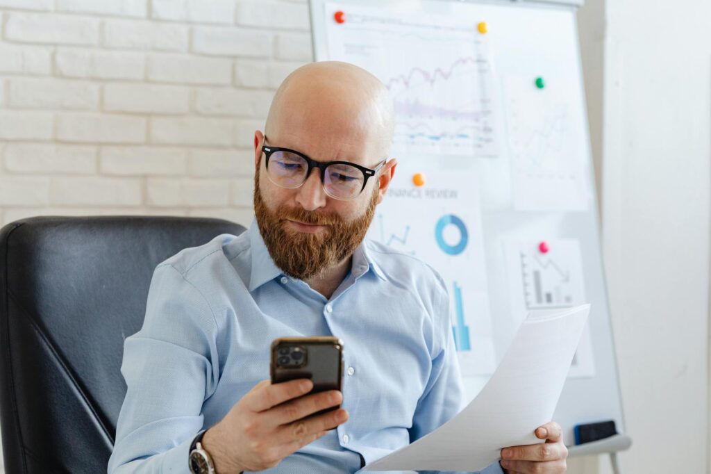 UK tradesman reviewing quote breakdown on phone