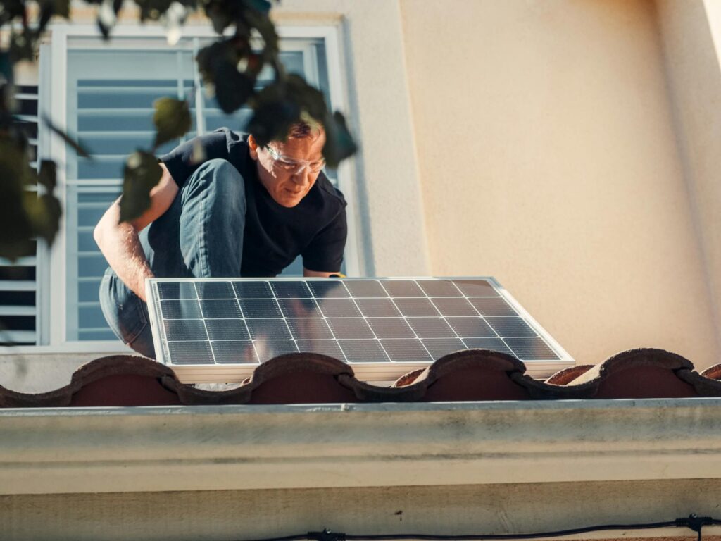 solar panels being installed on a UK residential roof, installer on scaffold