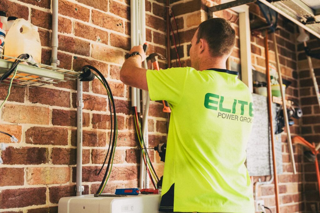 battery storage unit installed in garage alongside solar inverter