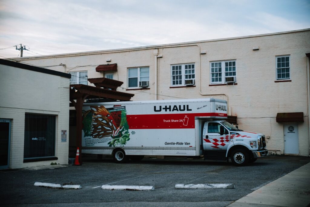 landscaper loading equipment into a branded van or truck, USA