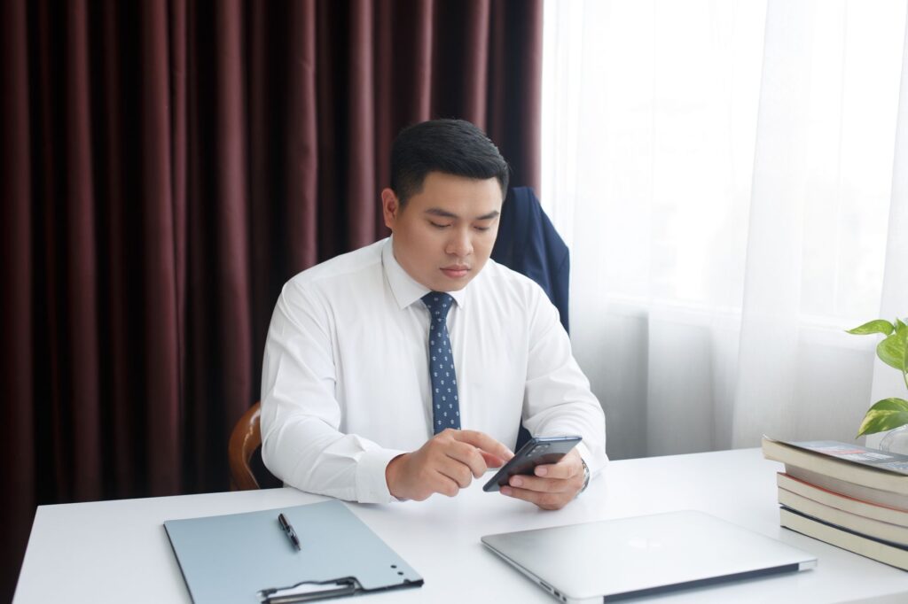 US contractor reviewing their job schedule and customer list on a smartphone between site visits