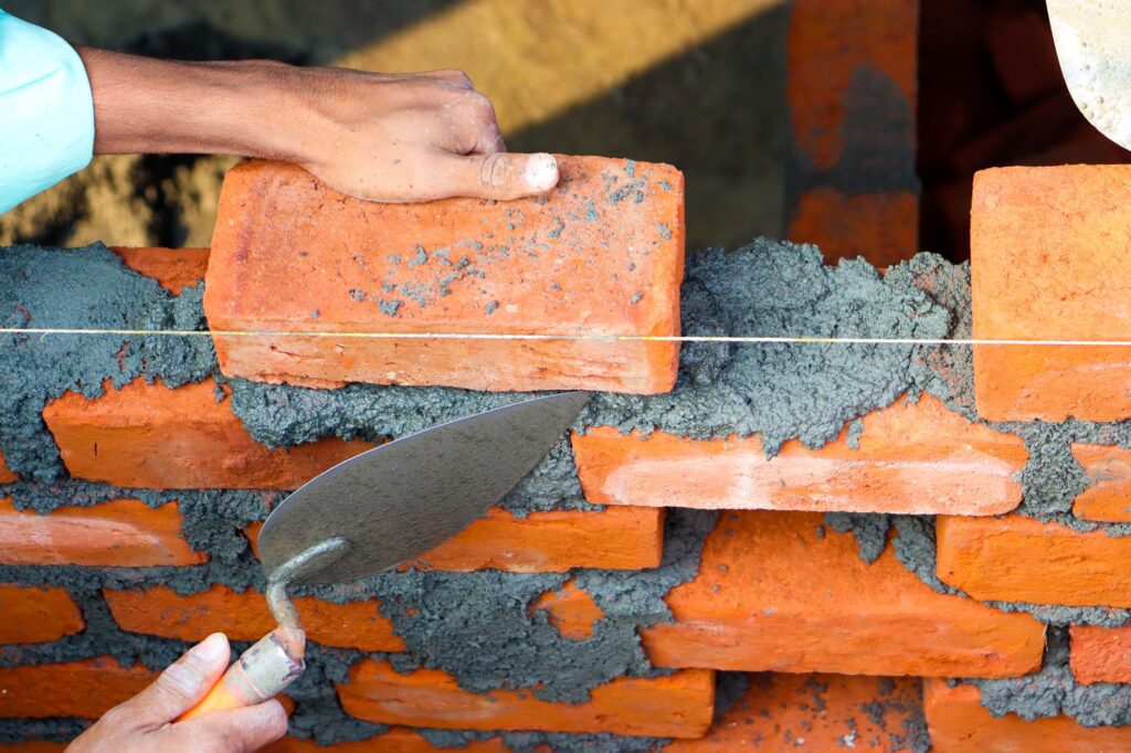 bricklayer completing quality work, professional result visible, USA