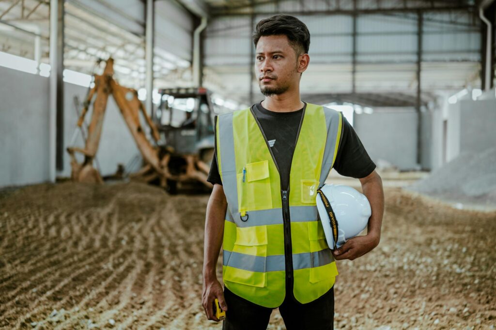 A contractor reviewing their schedule and active jobs on a smartphone app while sitting in a work truck
