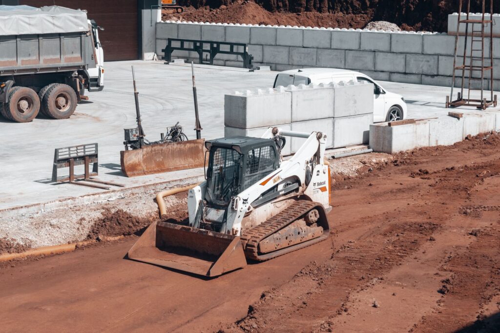 groundworker loading equipment into a branded van or truck, USA