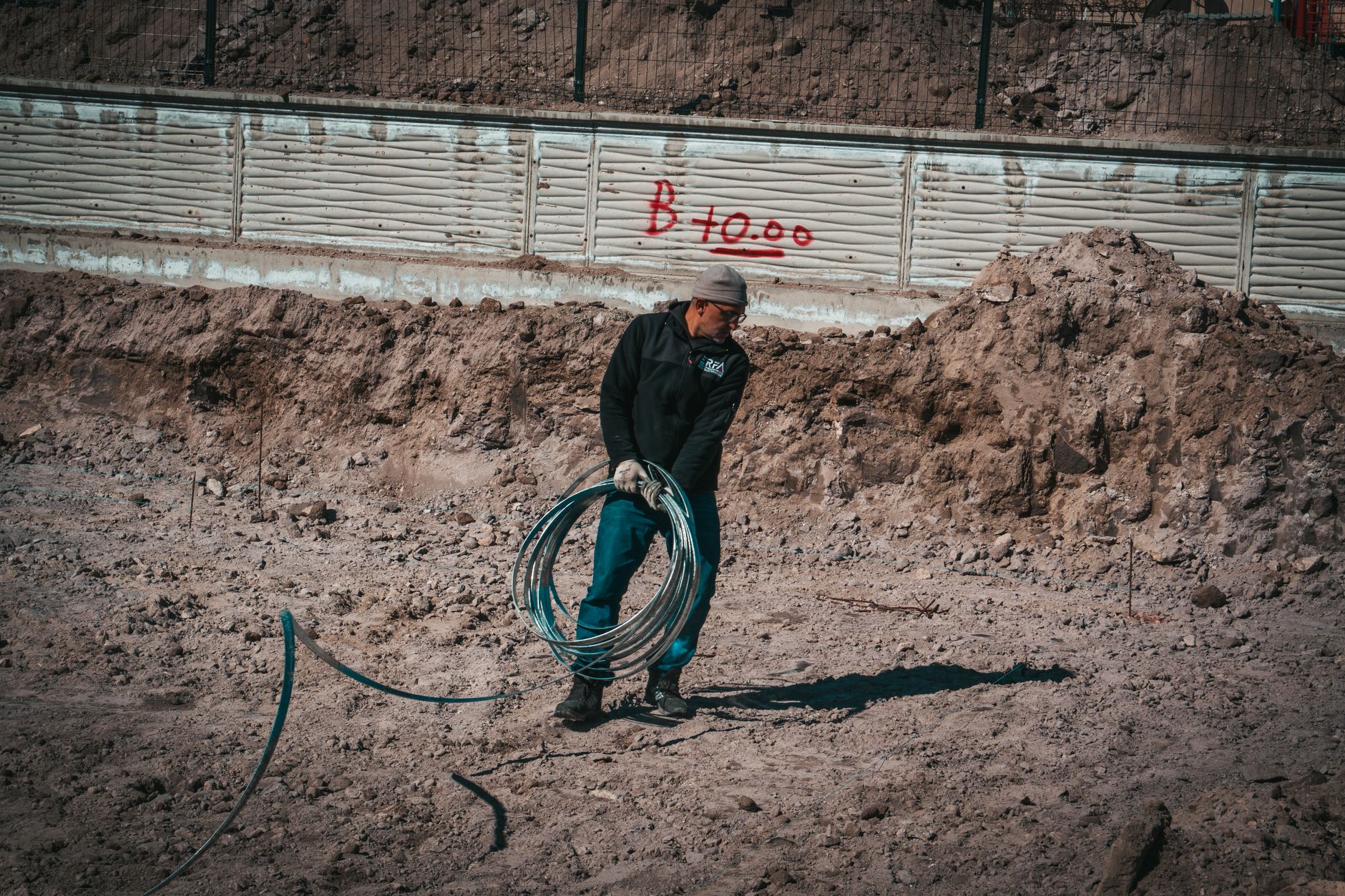 Professional groundworker on a civil engineering project in the USA, professional workwear