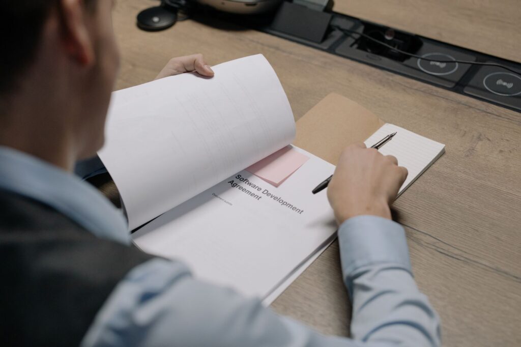 UK builder and client reviewing a job contract document together before work starts