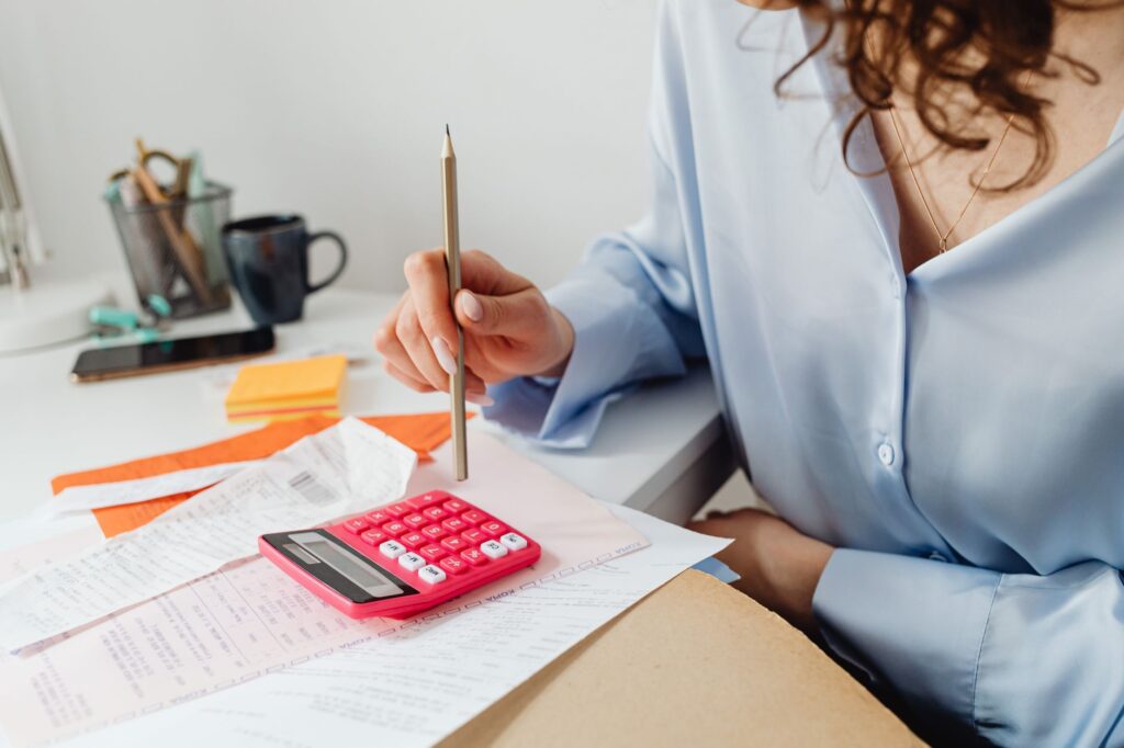 An electrician in a residential property sending an invoice from a phone app immediately after completing an installation