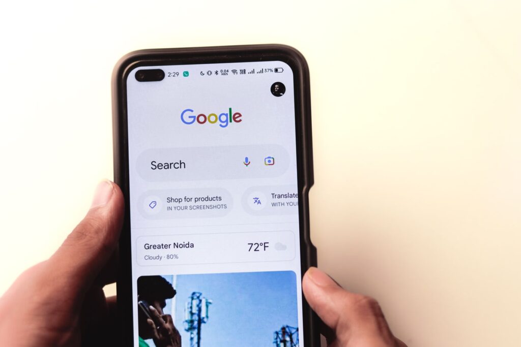 UK tradesperson reviewing their Google Business Profile on a phone while sitting in a work van